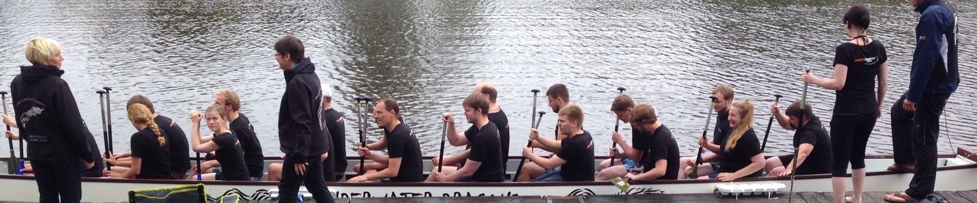 The energy & meteo systems team paddling a dragon boat.